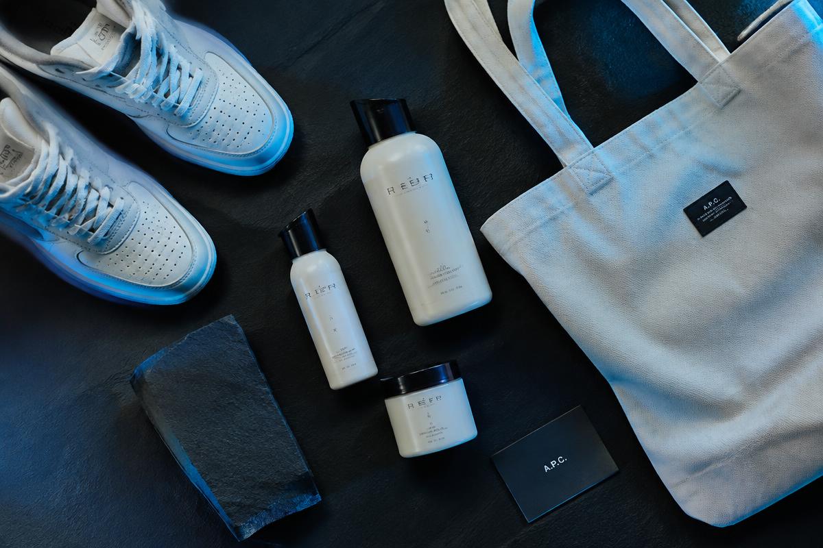 Skincare, sneakers and tote bag product flat lay